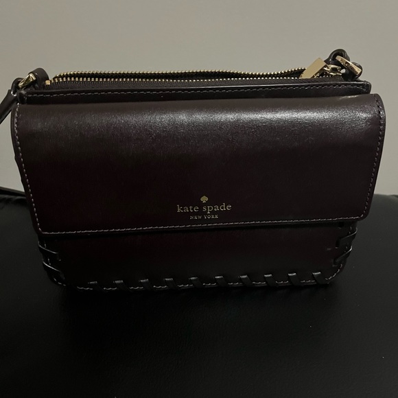 kate spade Handbags - Rich chocolate brown mini bag has an adjustable shoulder strap and gold letters